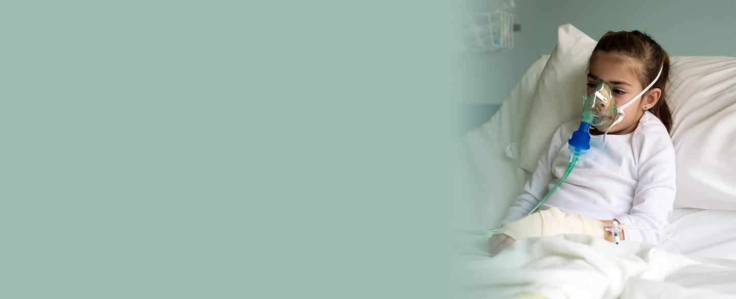 Young girl wearing an oxygen mask.