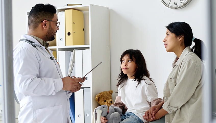 Doctor speaking to a mother and child