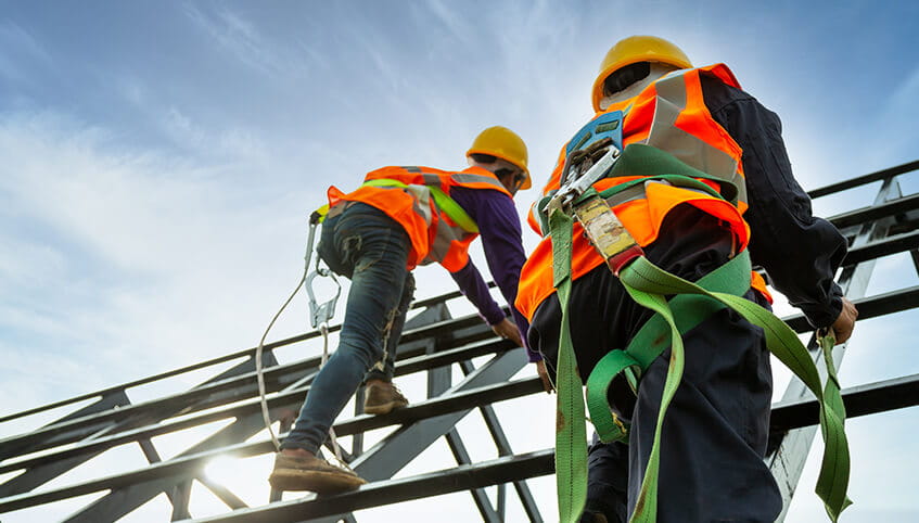 two men climbing scaffolding