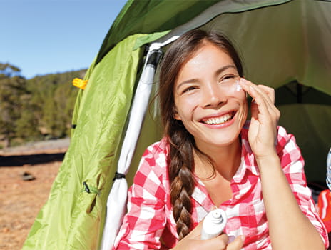 Woman applying sunscreen