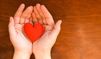 Hands holding a heart