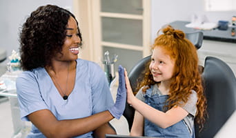 Doctor high-fiving a pediatric patient