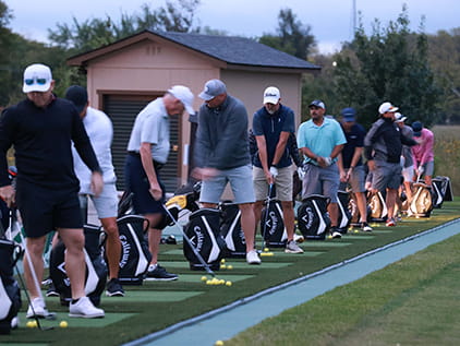 Golfers lining up to swing