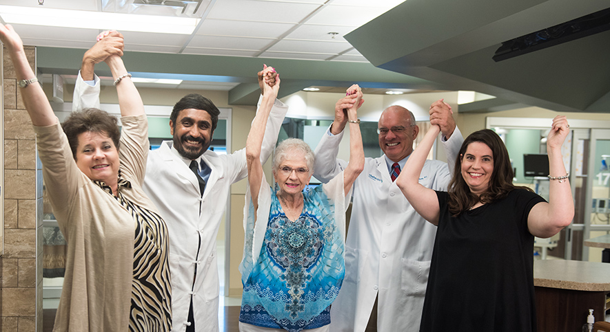 Three generations of cardiology patients with their doctors