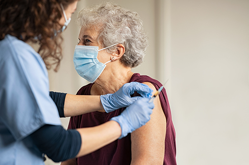 Older adult woman getting vaccine